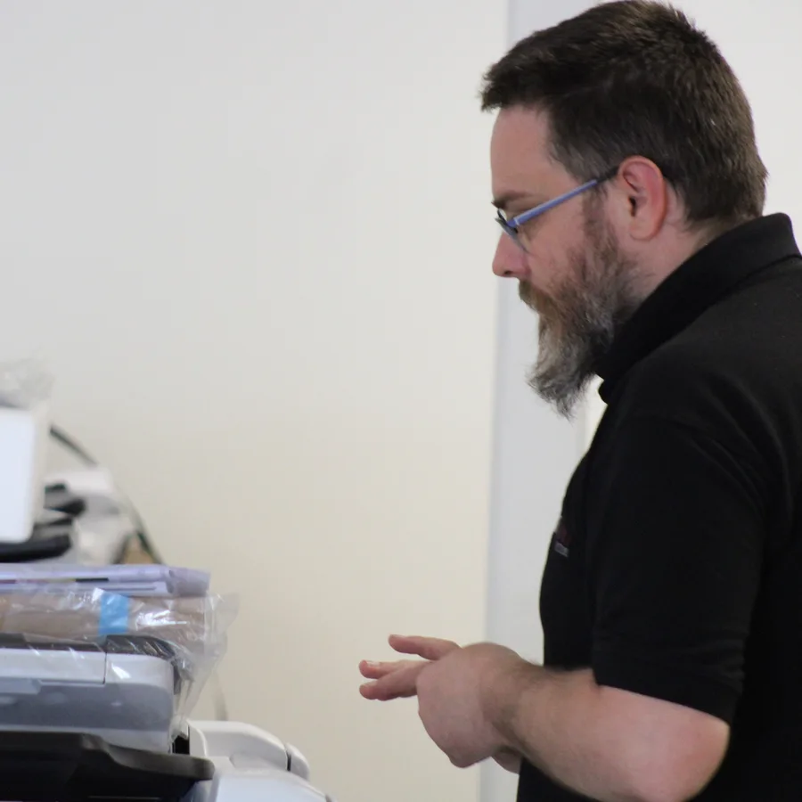 An engineer preparing boxed devices in the Insight Systems workshop
